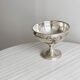 shiny silver metal cup on foot