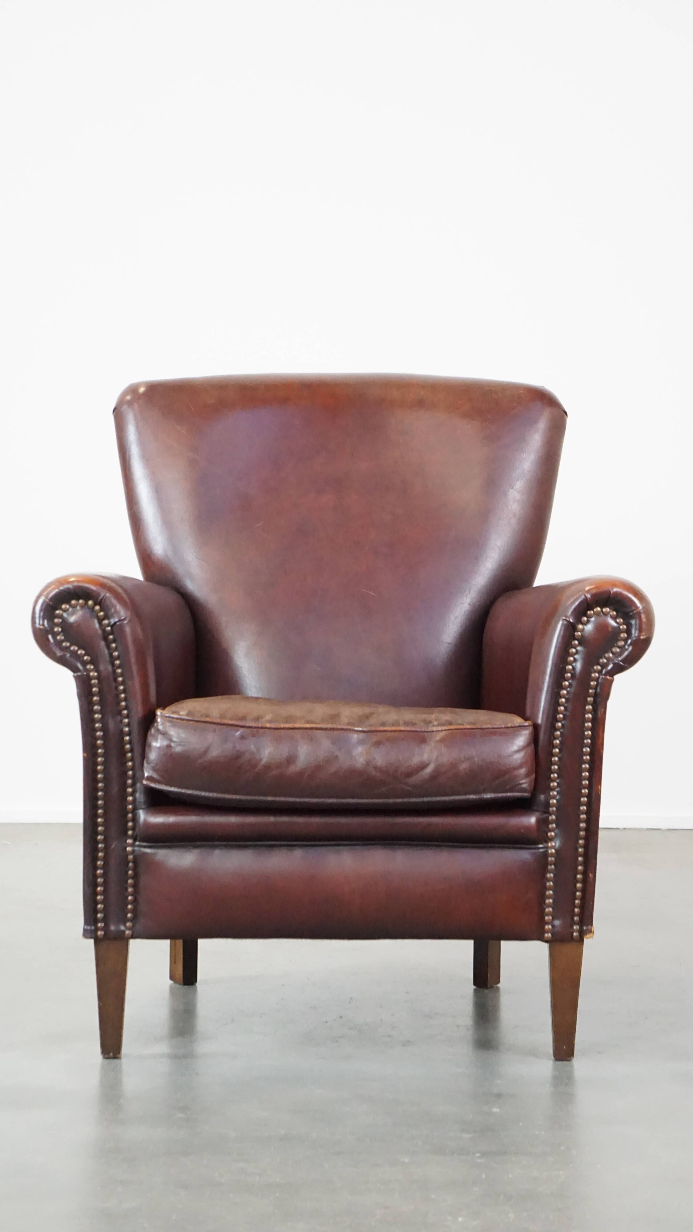 Sheep leather armchair correctly finished with decorative nails