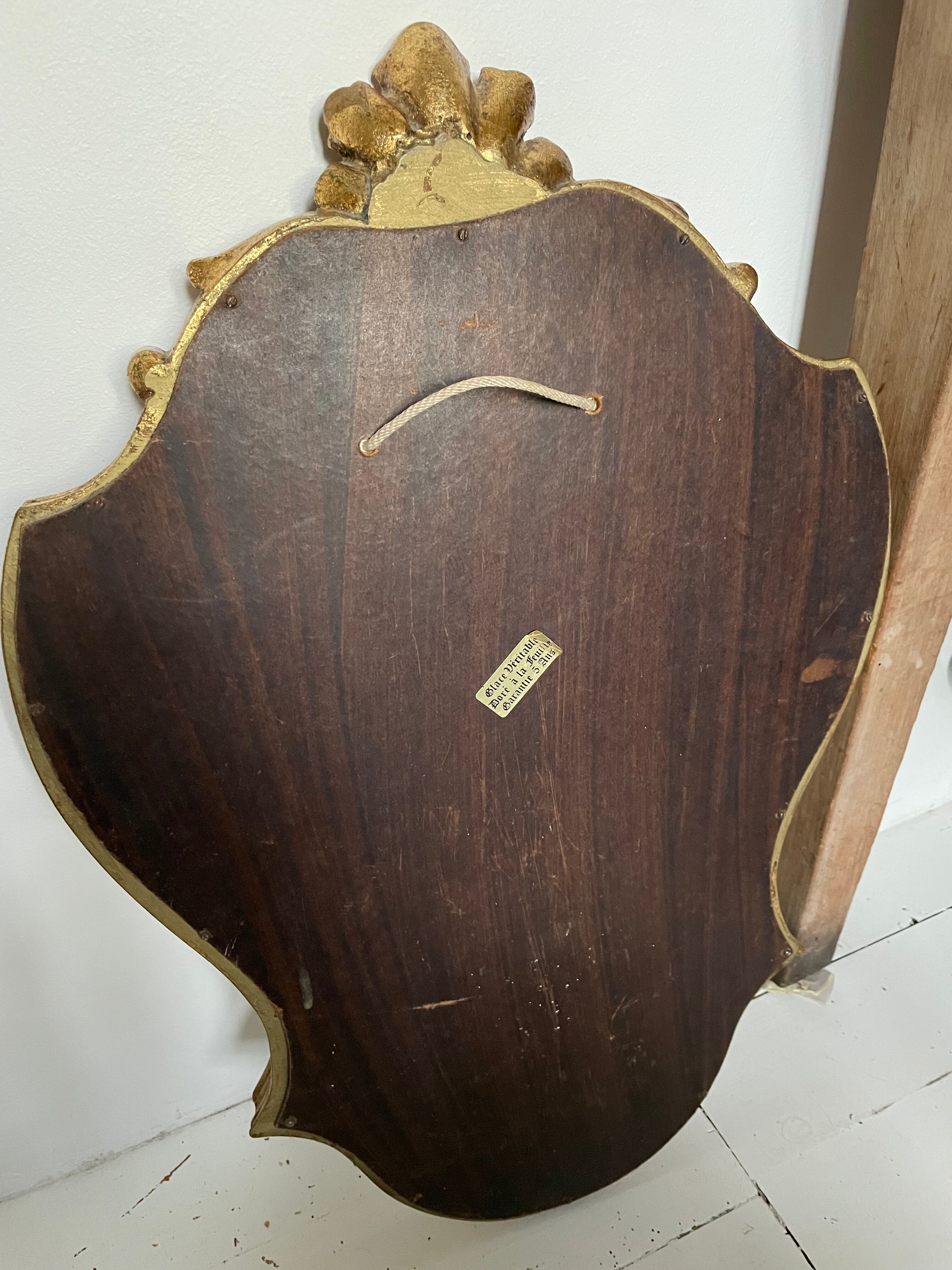 Golden rococo mirror with gold leaf