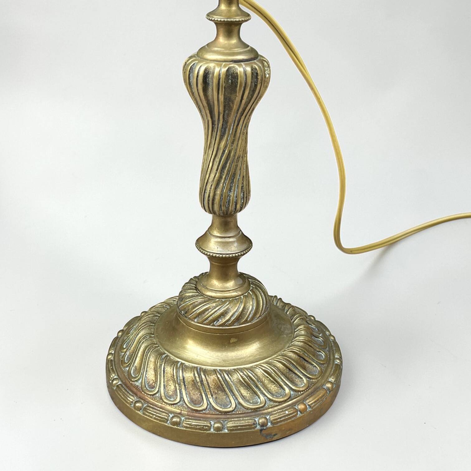 Antique brass foot lamp with glass globe and diamond point.