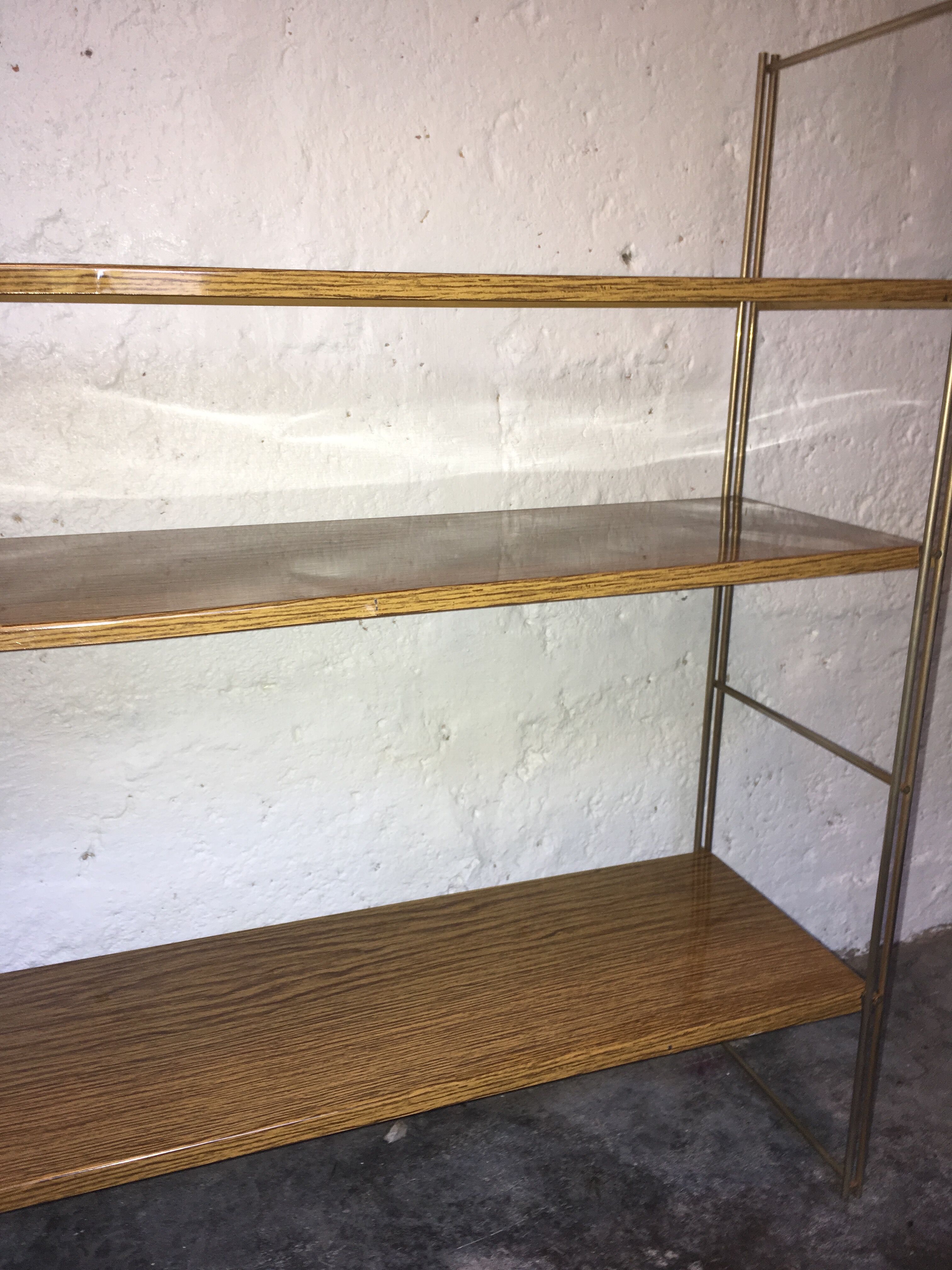 set of two 1960 vintage metal thong shelves.