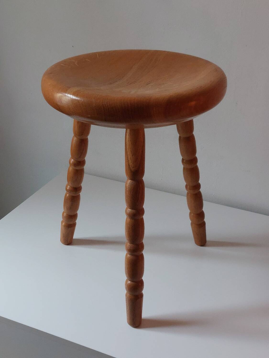Vintage en bois tourné tabouret du milieu du siècle avec un siège épais.