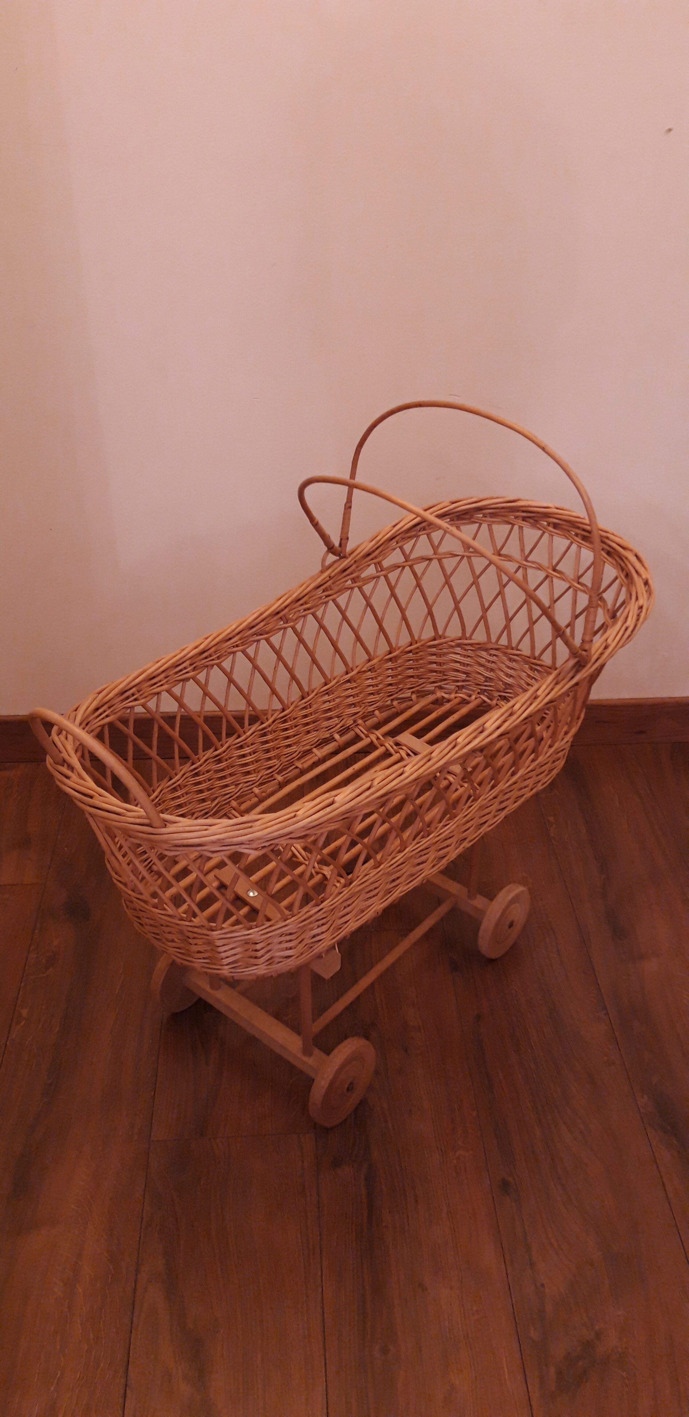 Vintage wicker cradle with wheels