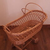 Vintage wicker cradle with wheels