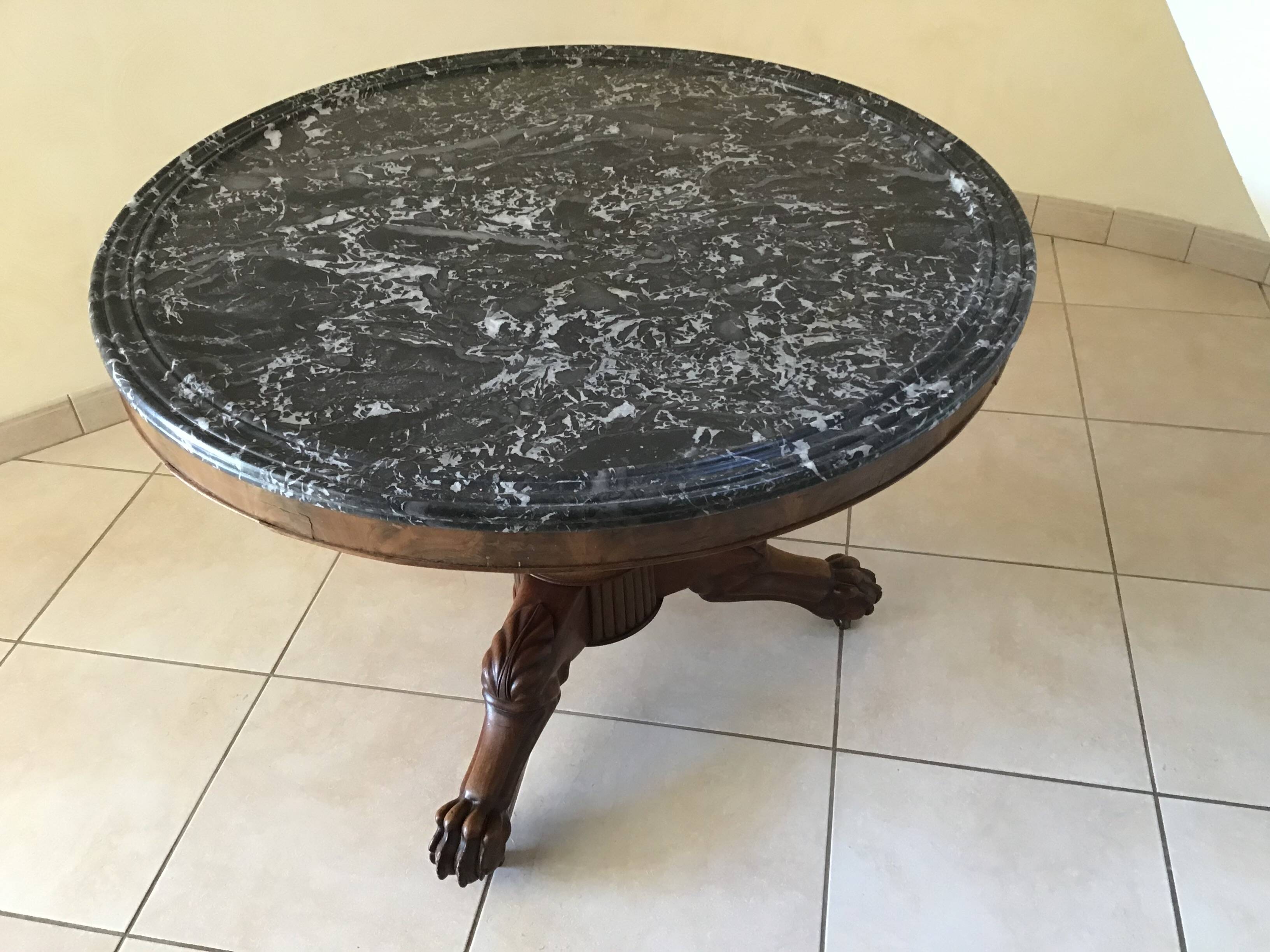 Wooden gueridon with marble, lion paw legs.