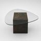 Unique design coffee table with natural stone base and organic glass top