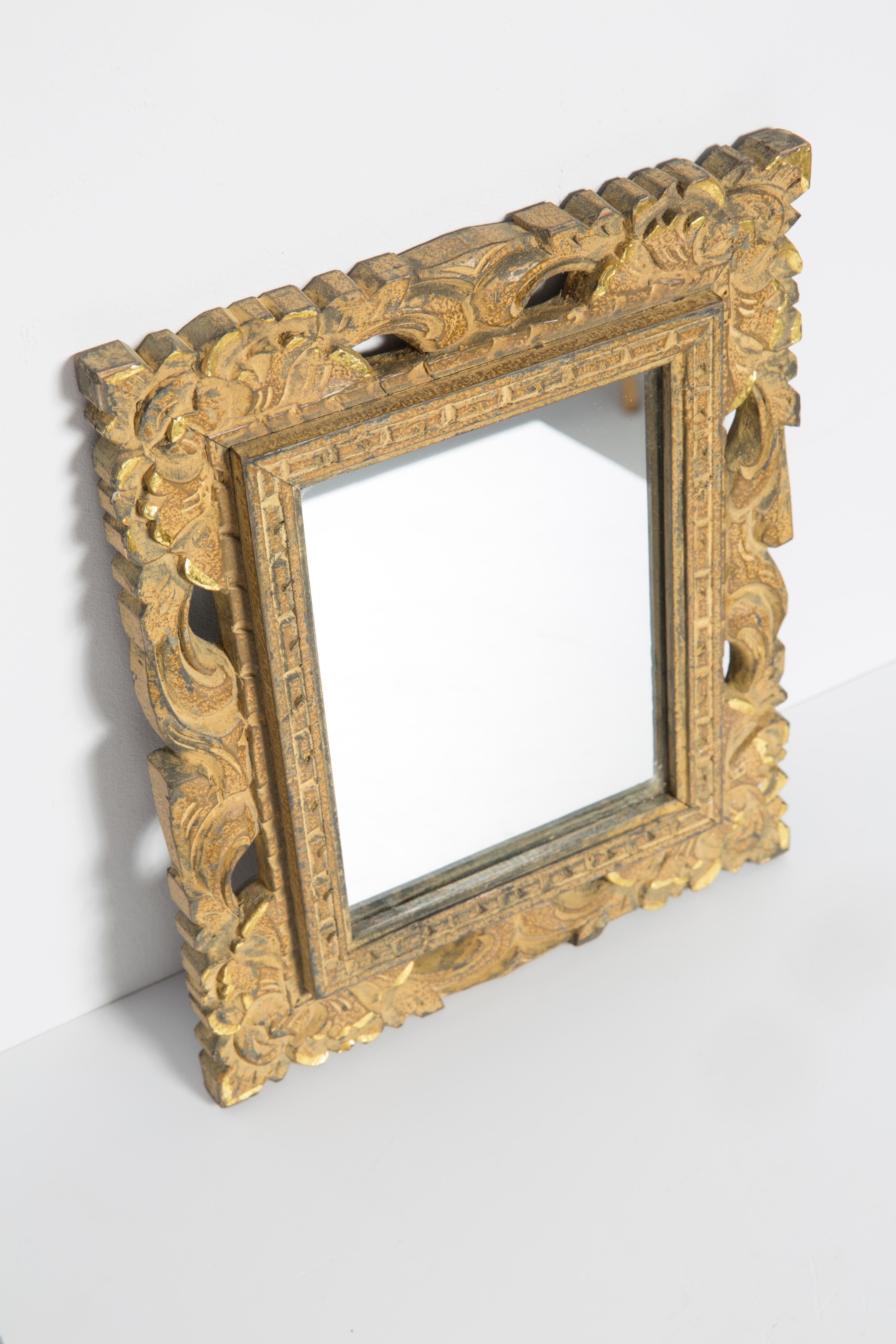 Decorative gold mirror mid-century in a wooden frame, Italy, 1960s.