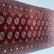 Antique wool rugs with designs on a red background, 20th century.
