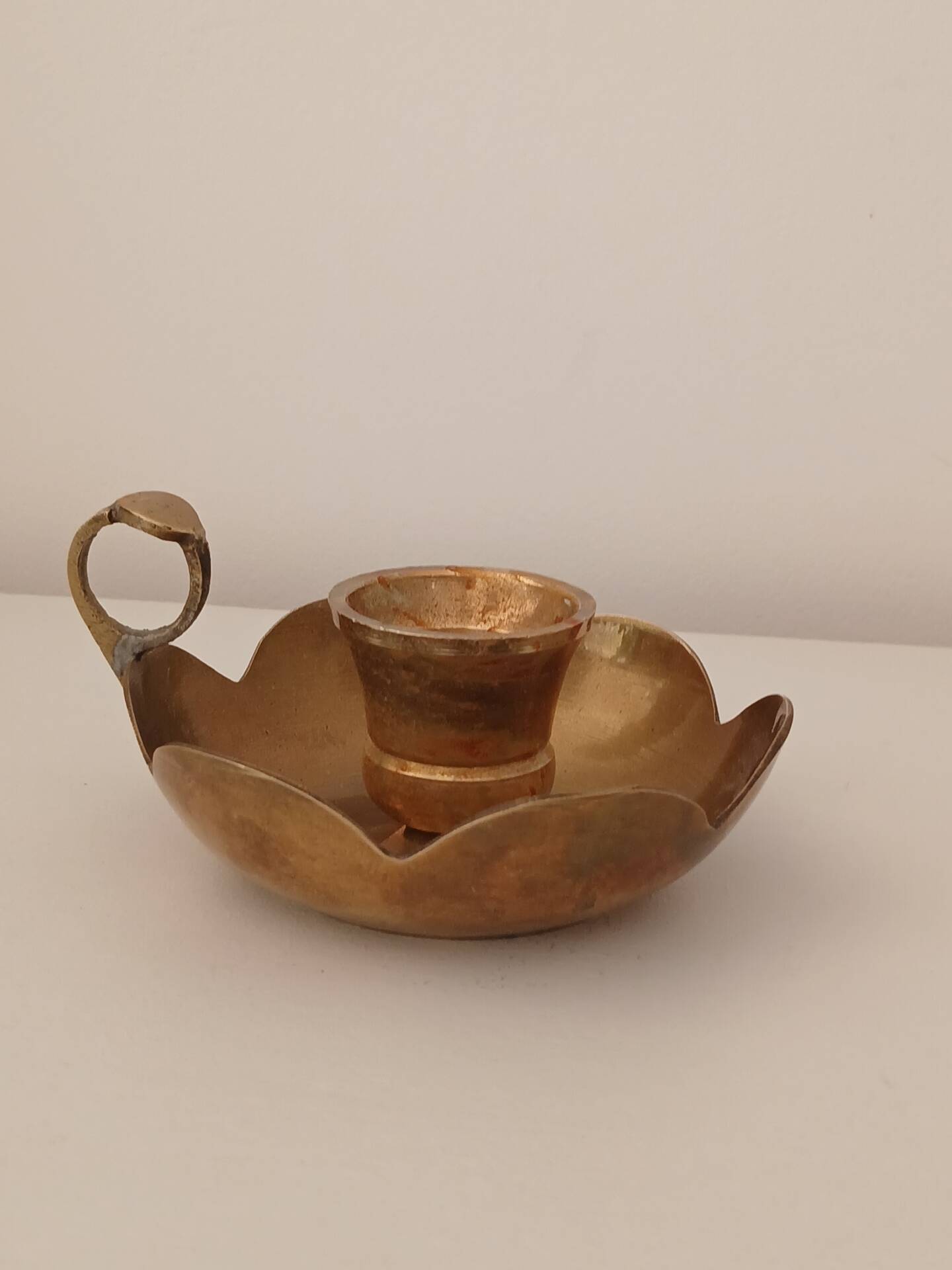 Brass candle holder in the shape of a flower.