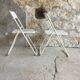 Pair of white perforated metal folding chairs - vintage