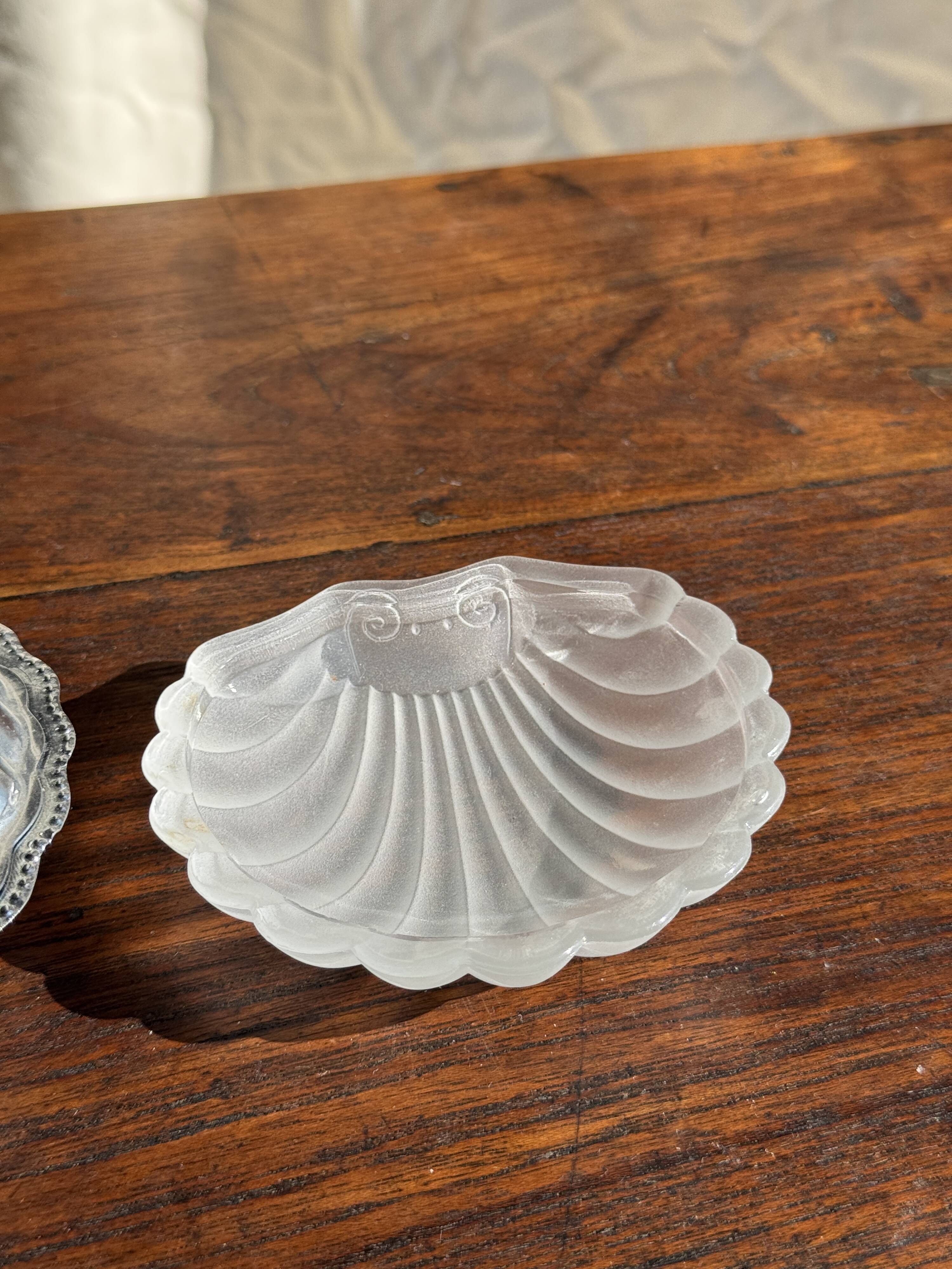 Vintage silver-plated shell butter dish with transparent bowl.