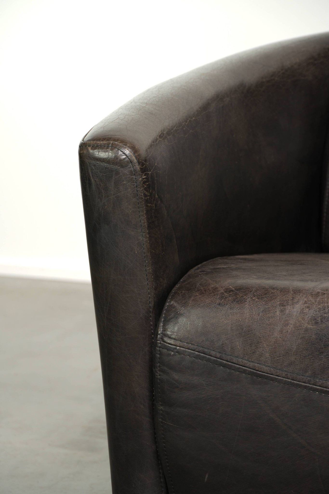 Cow leather Aviator design armchair in a dark colour scheme