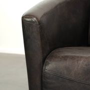 Cow leather Aviator design armchair in a dark colour scheme