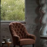 Victorian mahogany armchair, with wheels and coloured fabric, England, early 1900s.