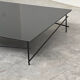Minimalist black glass coffee table with industrial metal base