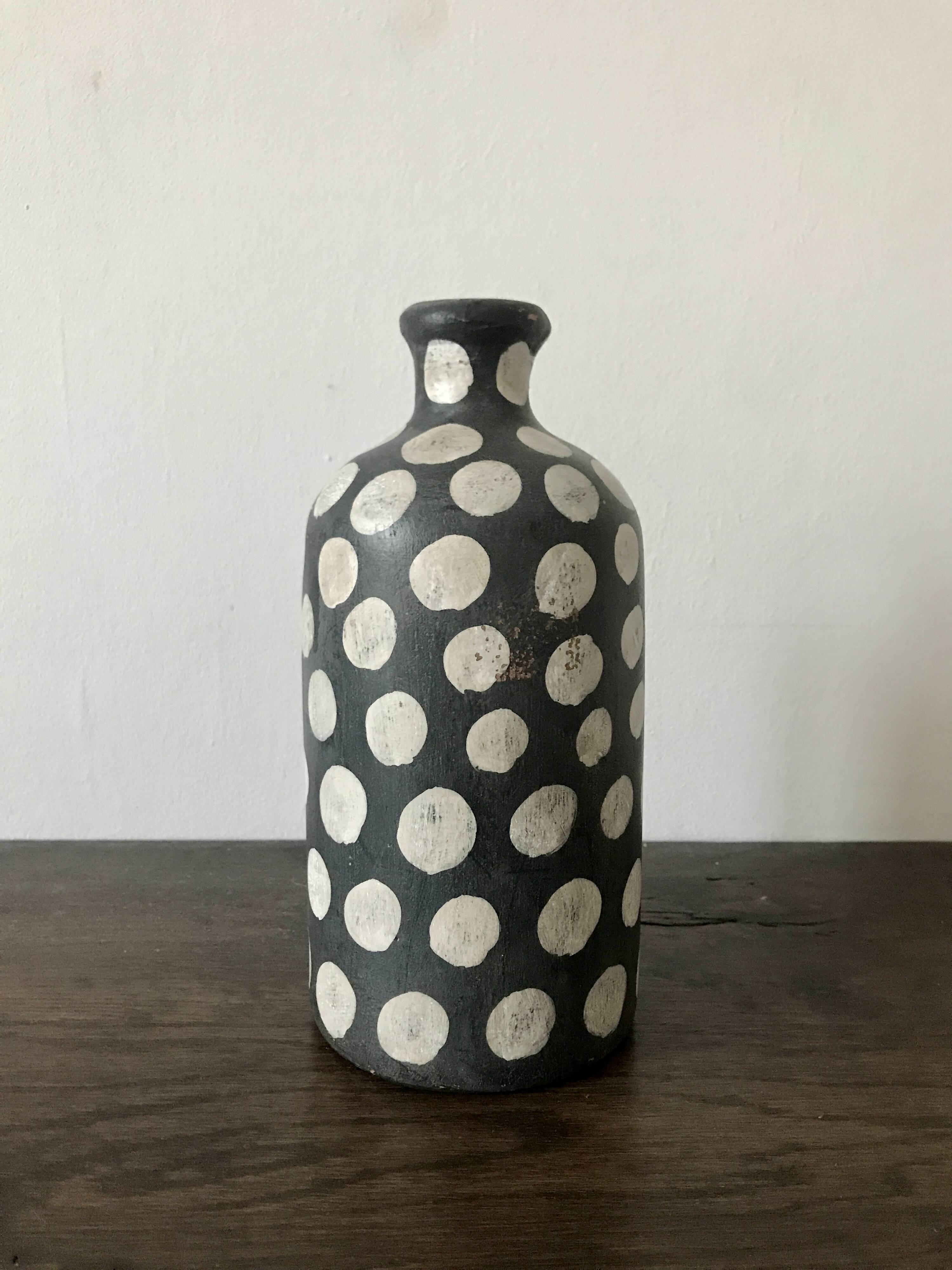 Terracotta vase painted with polka dots