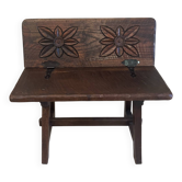 Small antique wooden bench with a folding backrest.