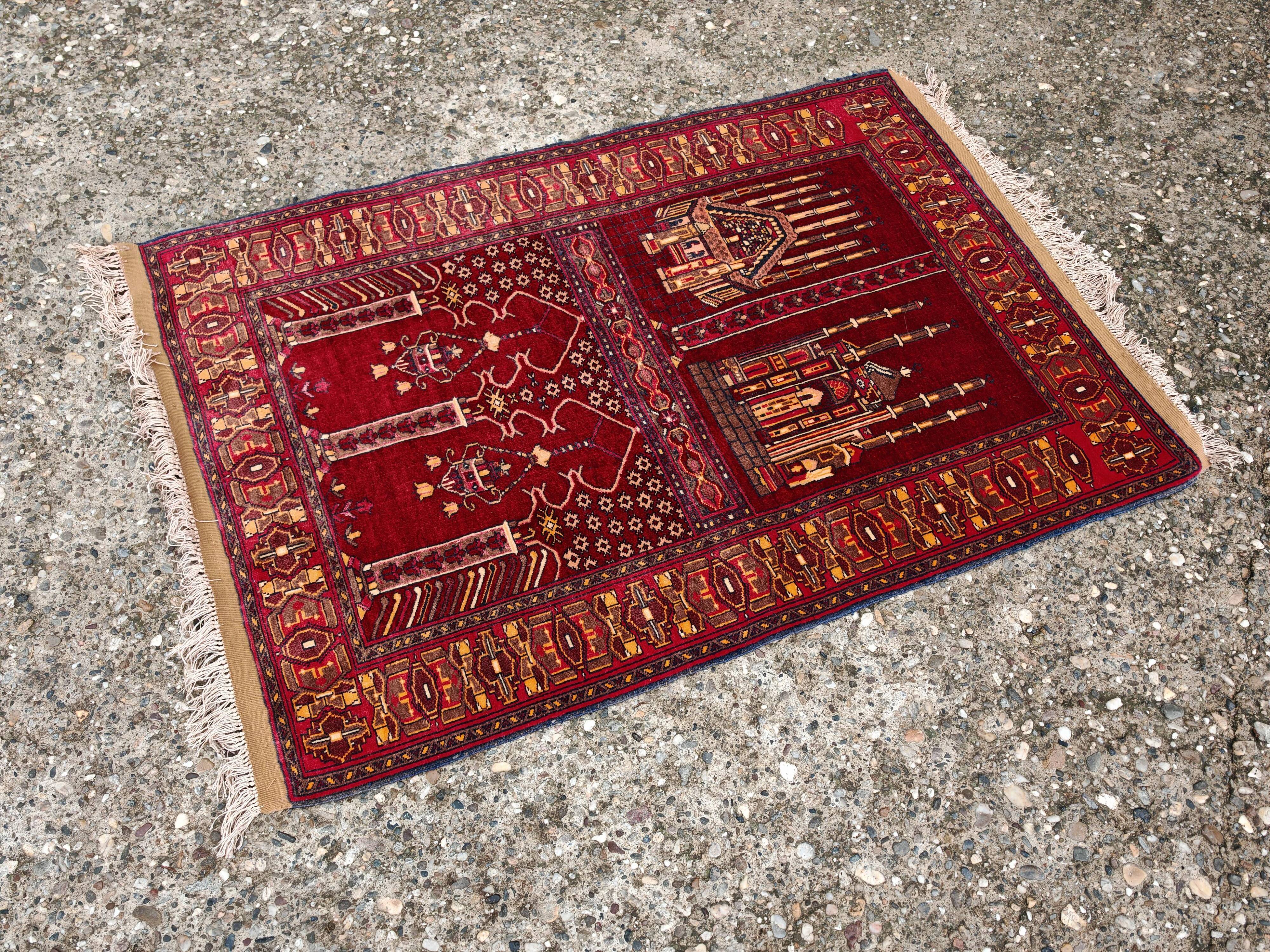 Vintage Afghan hand-knotted prayer rug with Islamic patterns.
