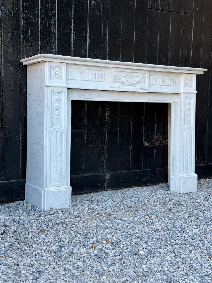 Louis XVI style fireplace in white Carrara marble, circa 1880.