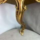 Small corner console in resin with a gold finish.