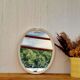 Vintage enamelled metal oval mirror