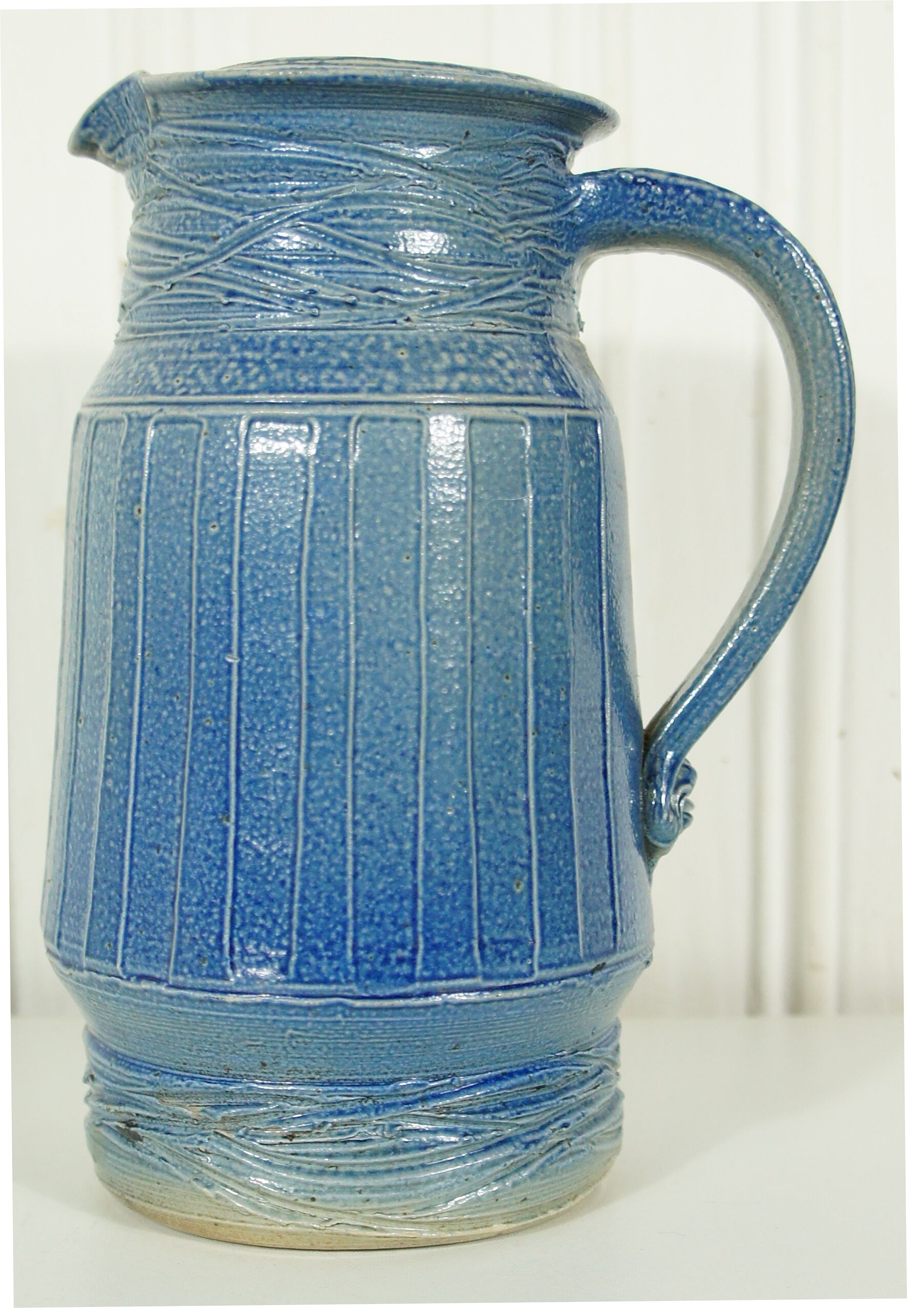 Pitcher in glazed blue sandstone signed