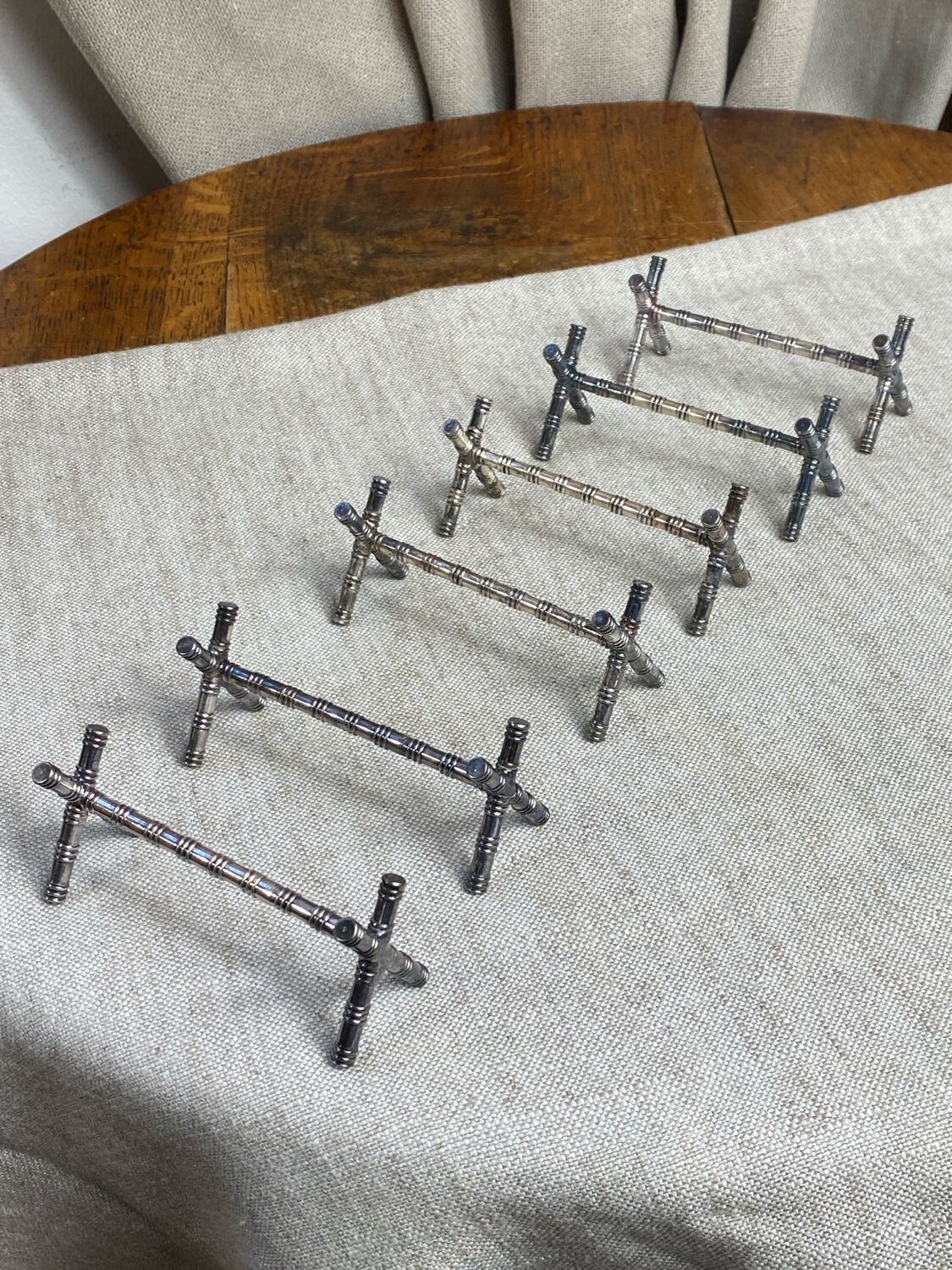 Six bamboo-patterned metal silver-plated knife rests.