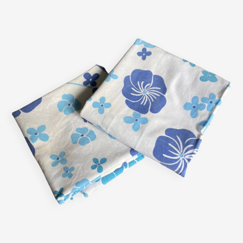 2 vintage cotton pillowcases with blue floral patterns.