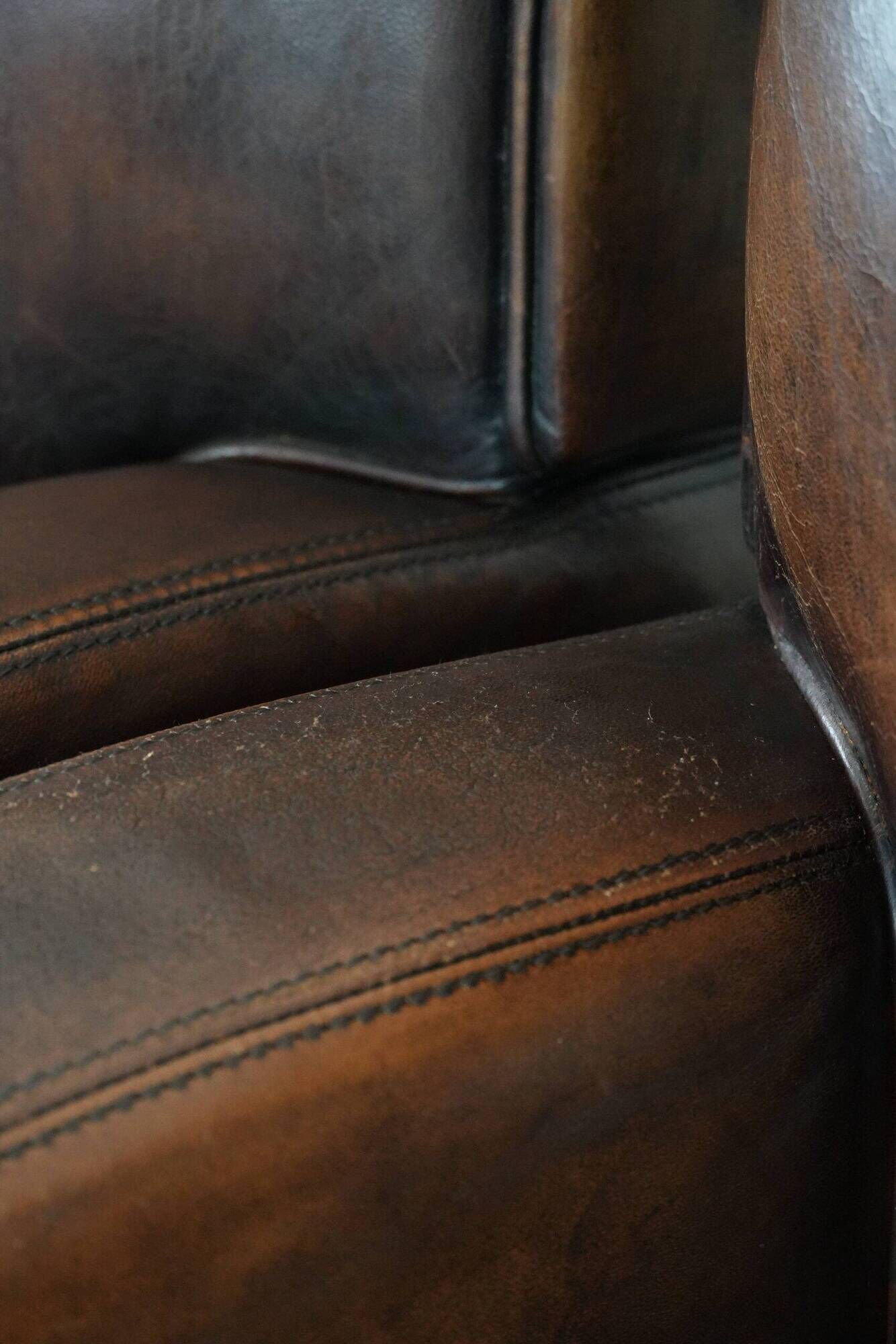 Characterful set of two vintage sheepskin armchairs with beautiful colours