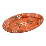 Portuguese XL dish in orange enamelled clay with unbleached flowers and green leaves