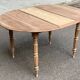 Renovated 18th century solid wood extendable round dining table with shutters