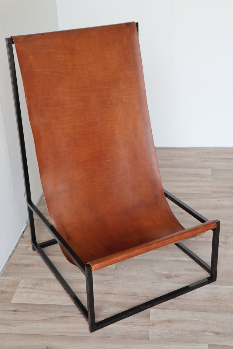 Pair of vintage armchairs in stretched leather and metal structure