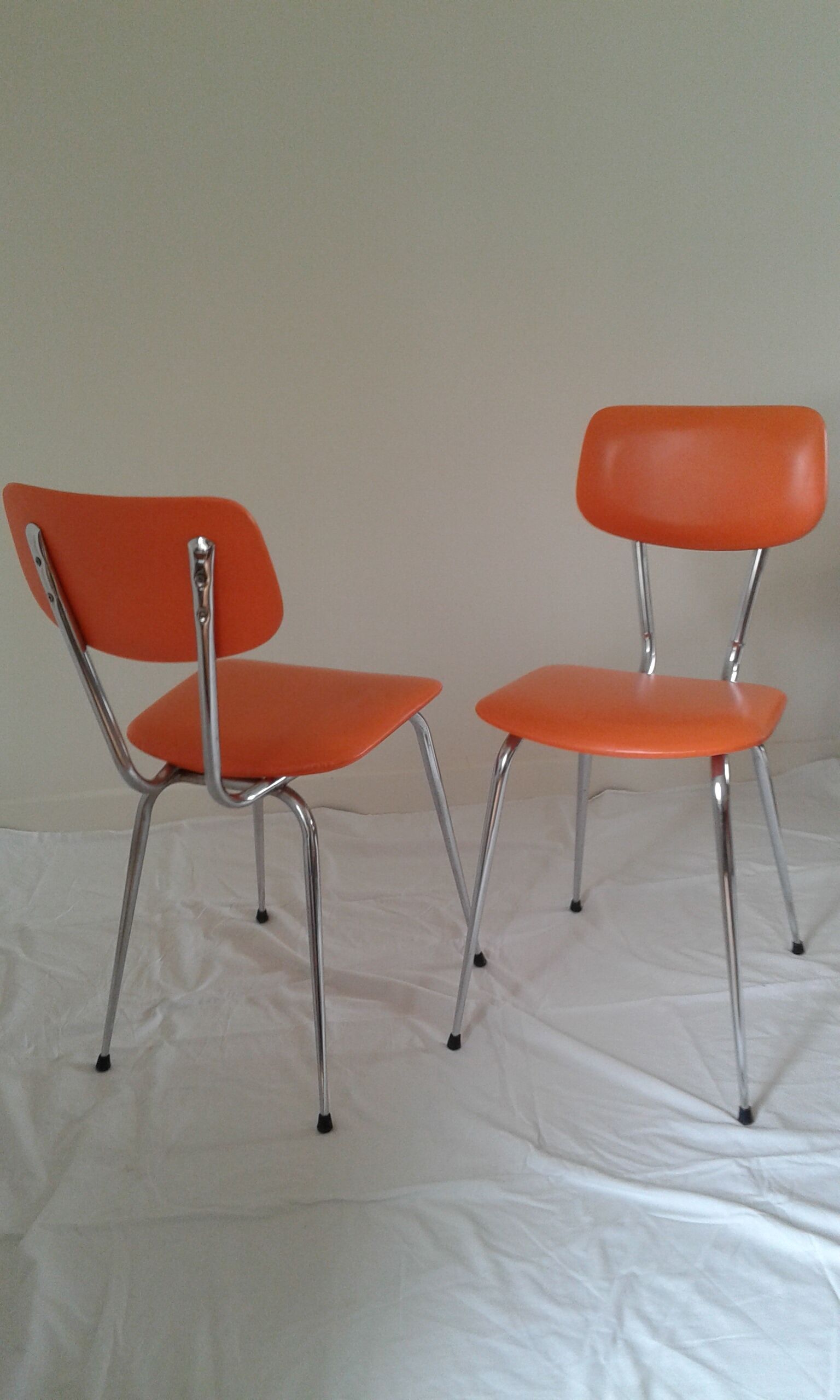 Duo of vintage chairs in orange skai