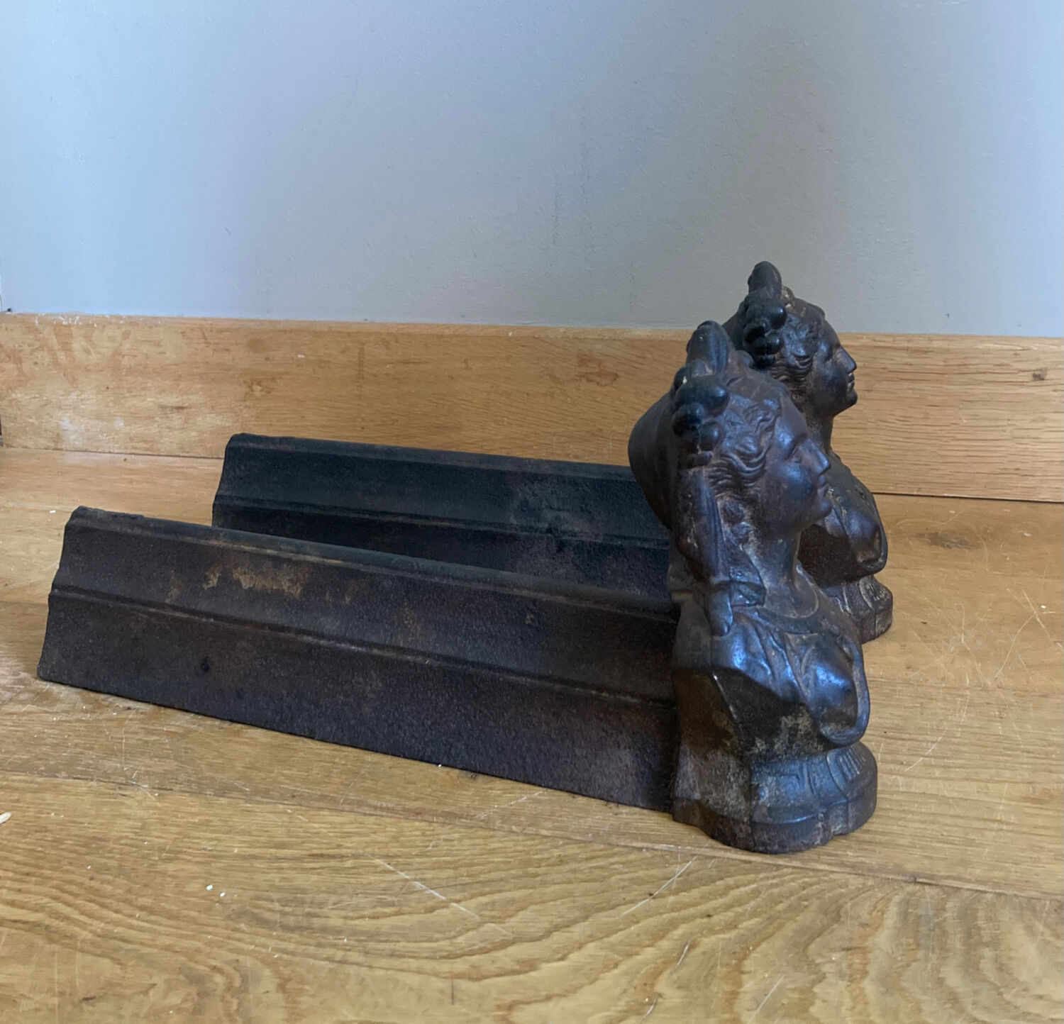 Pair of cast iron andirons from the 19th century, busts of women