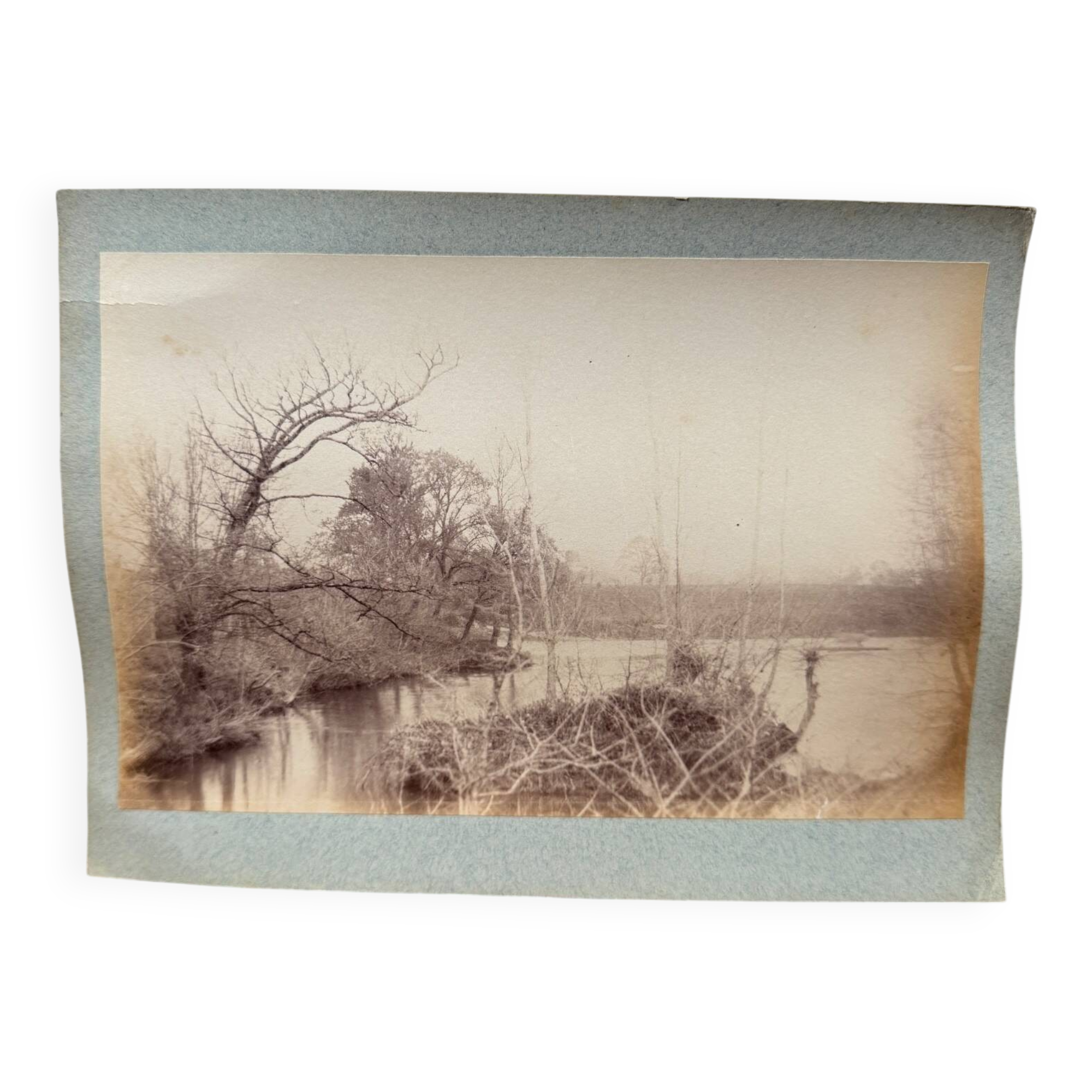 Photo album glued onto cardboard depicting a 19th-century watercourse.