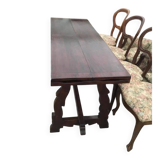 19th-century brown walnut dining table with sculpted trestle legs.