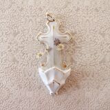 Antique holy water font in white porcelain biscuit.