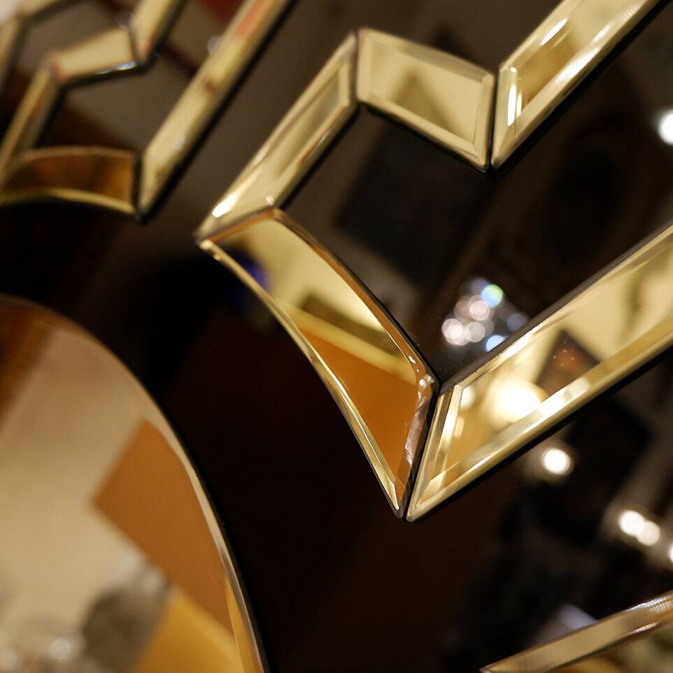 Pair of black and gold glass mirrors