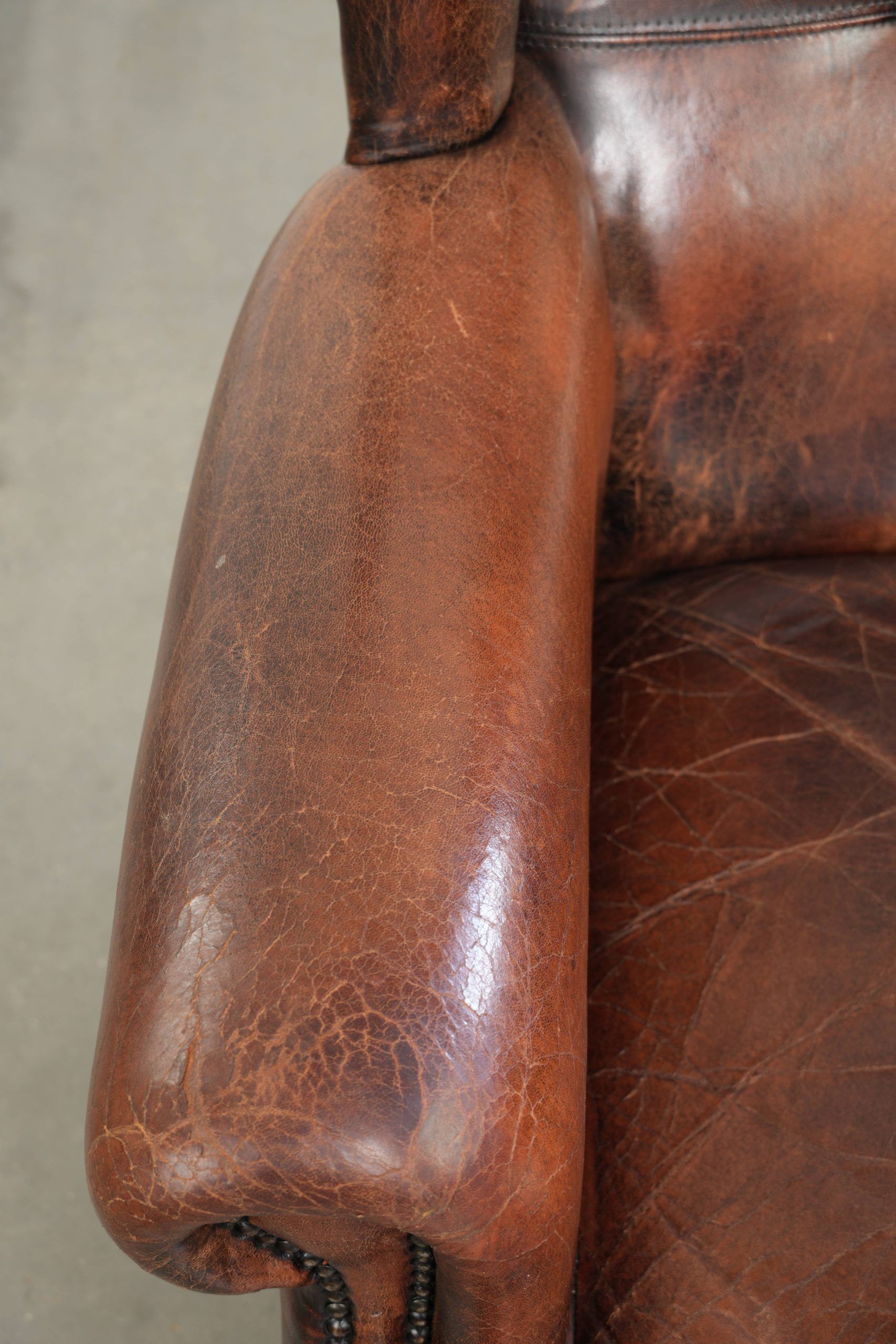 Vintage sheepskin wingback armchair in a deep brown colour finished