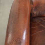 Vintage sheepskin wingback armchair in a deep brown colour finished