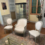 Armchair and 2 chairs set in Louis XVI style, light fabric, patinated wood.