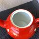 Vintage red teapot with white polka dots