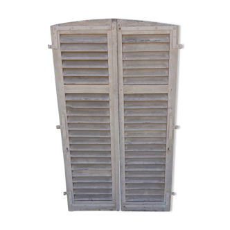 Pair of arched shutters with louvers