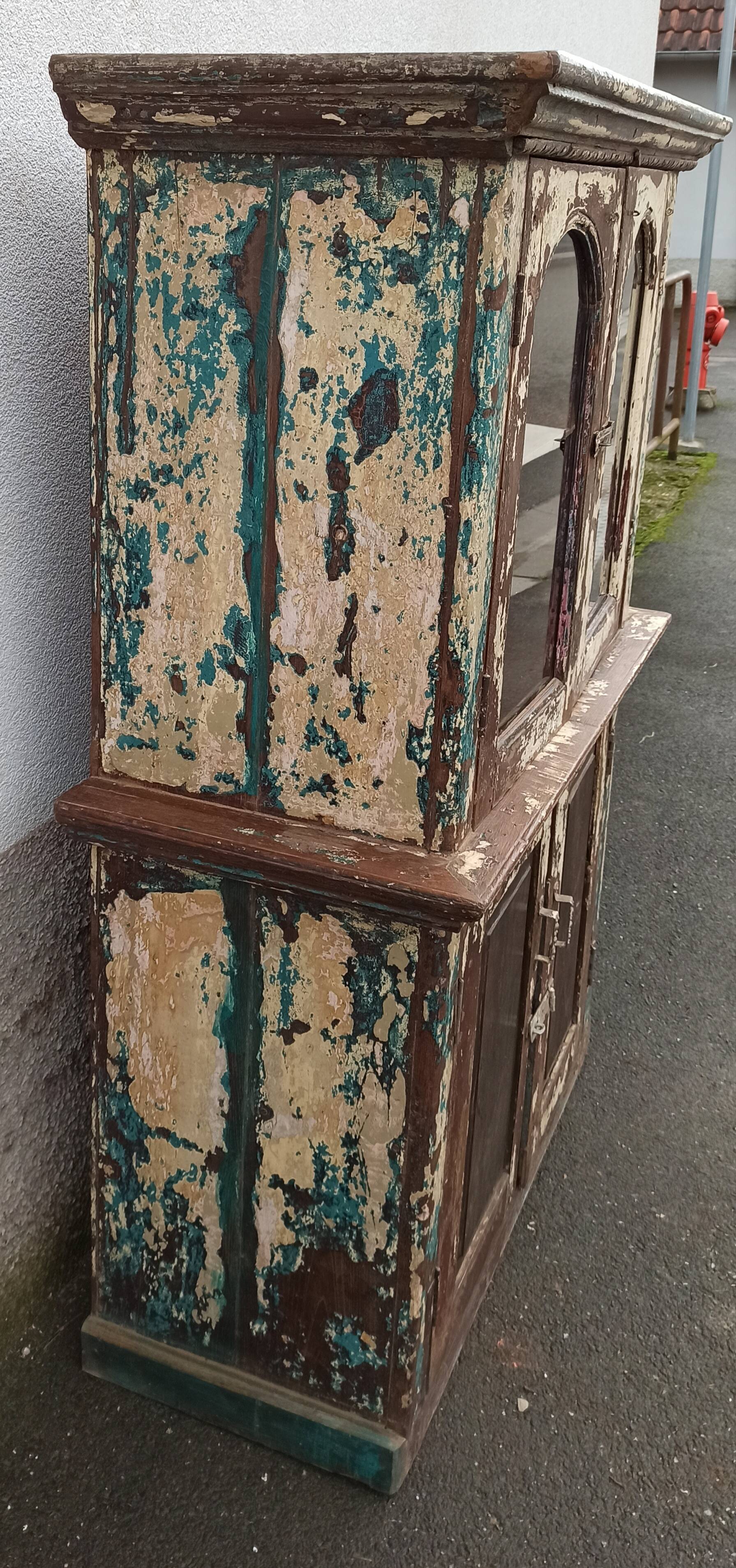 Old patinated wooden glass cabinet
