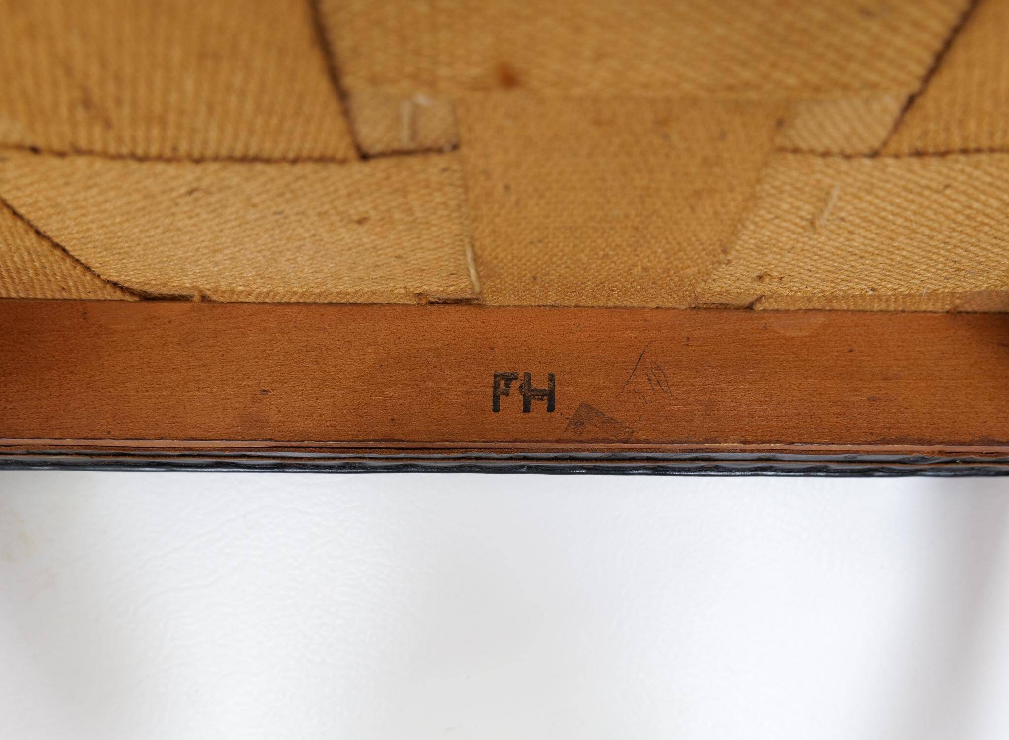 Mid-century armchair by Ole Wanscher for Fritz Hansen, stained beech and leather.