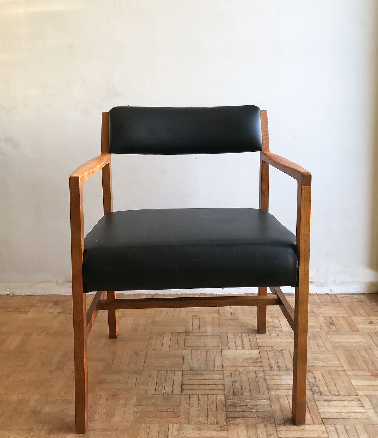 Chair in light teak and black skaï from the 1960s