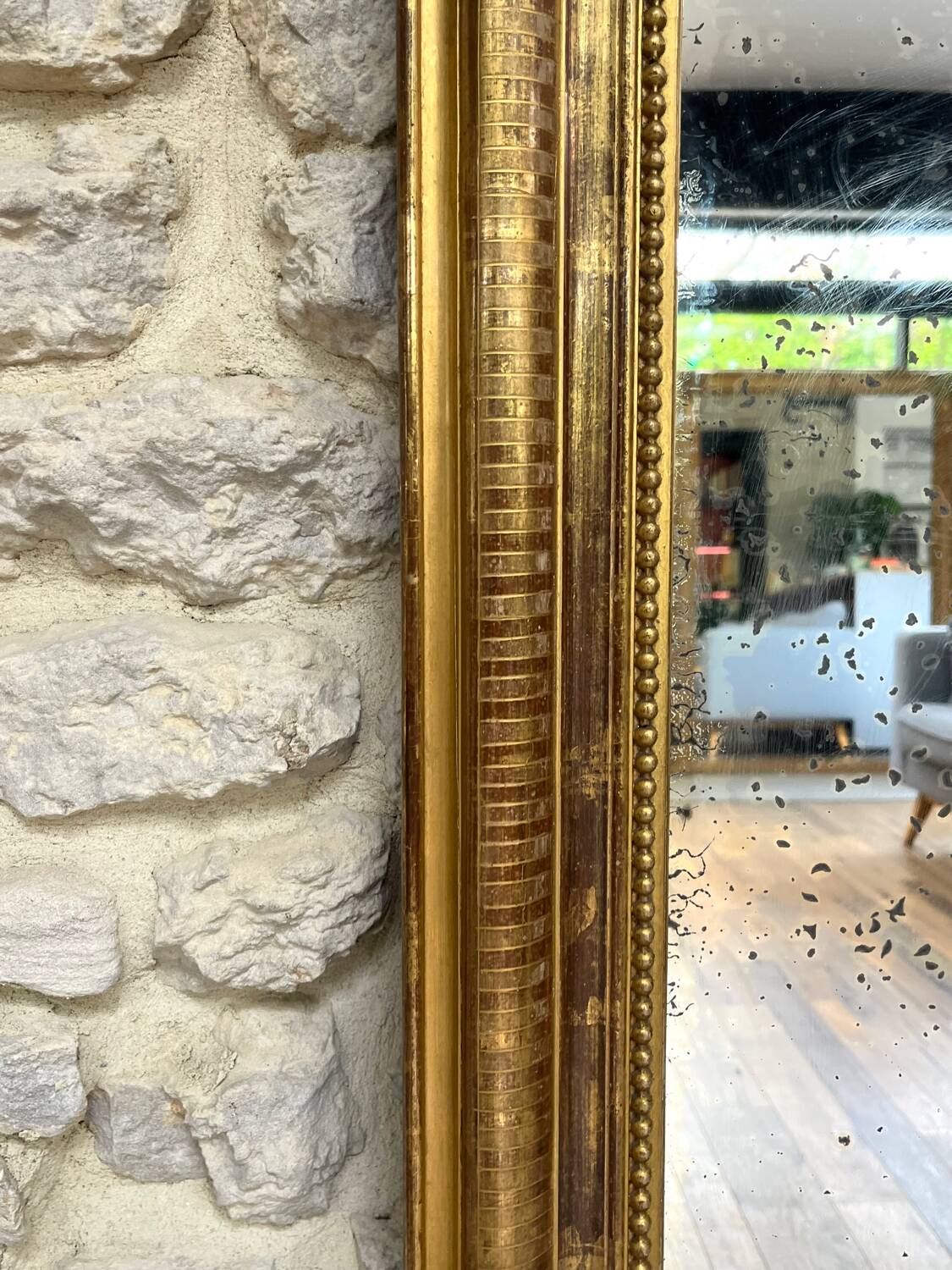 Louis-Philippe mantel mirror 133cm/115.5cm beaded gilded with gold leaf geometric decoration, late 19th century, heavily pitted and scratched glass, parquet on the back.