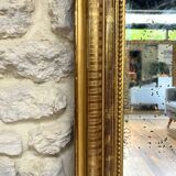 Louis-Philippe mantel mirror 133cm/115.5cm beaded gilded with gold leaf geometric decoration, late 19th century, heavily pitted and scratched glass, parquet on the back.