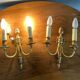 St Louis XVI gilded bronze wall lights with foliage and pine cone decorations