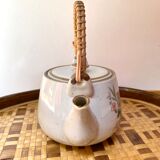 Vintage teapot in stoneware handle in rattan